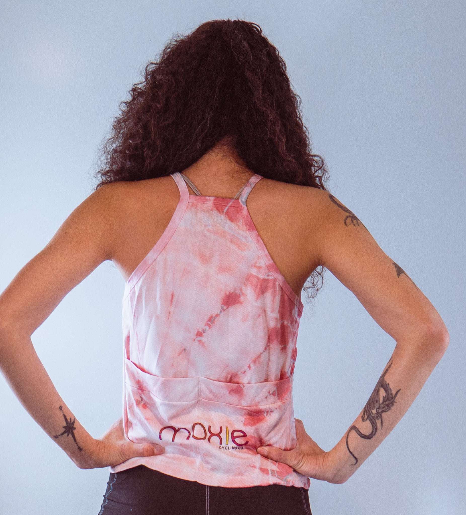 Women's sleeveless tie dye bike top with back pockets and strappy design in high visibility colors